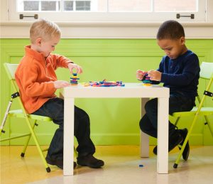 Kids Sitting at School Table Playing