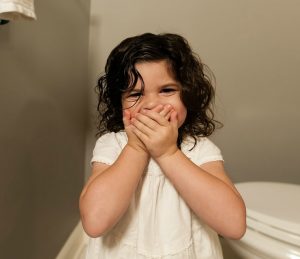 Girl Covering Mouth While Laughing