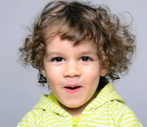 Smiling Boy with Curly Hair